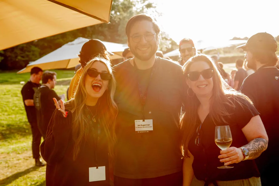 Three Close teammates smiling in golden evening light