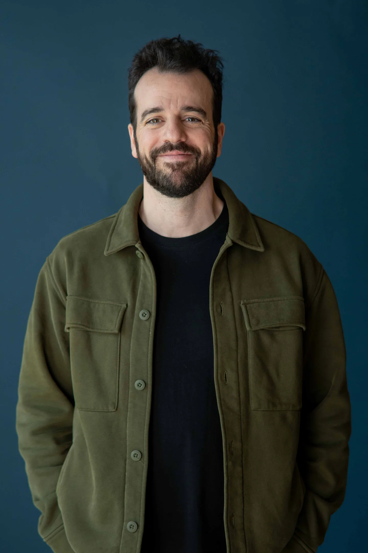 Steli Efti, Close co-founder and CEO, smiling in front of a dark blue backdrop